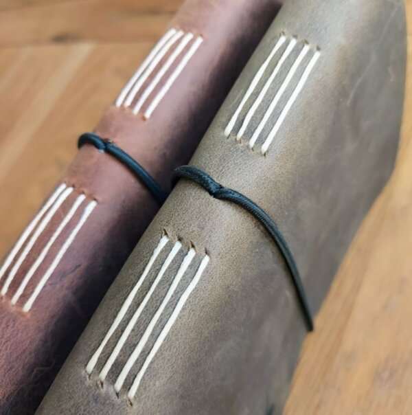 long stitch spines on rustic leather golf log journal by Bespoke Bindery