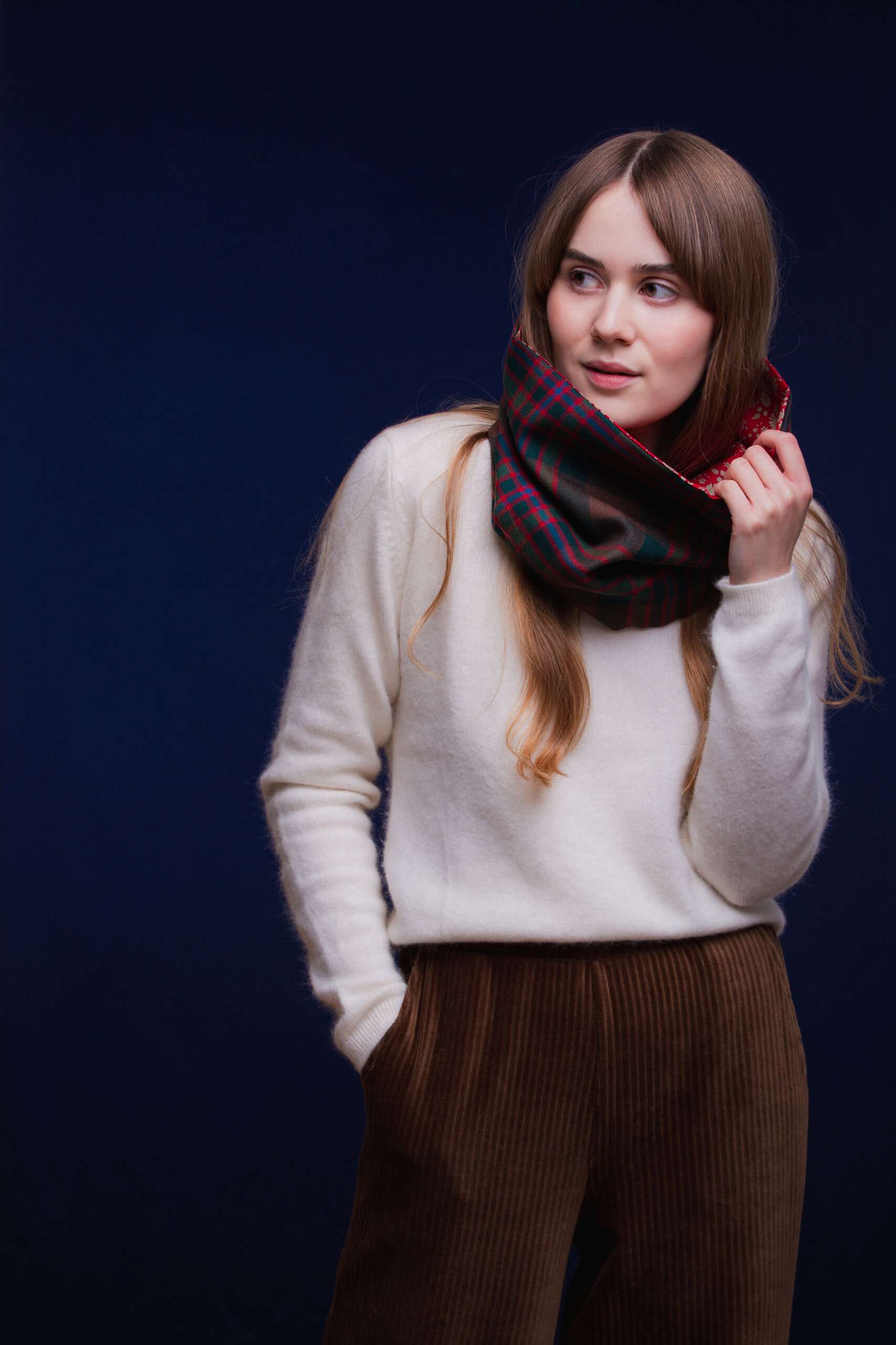 LoullyMakes Studio 4 51 scaled Classic Cowl in our own exclusive John Muir Way Tartan with Liberty Print tana lawn cotton lining. Simply select your choice of coloured lining from the drop-down menu. ( The example cowl pictured here features lining 5 ) This easy-to-wear cowl combines effortless styling and sublime warmth, being formed from a simple superfine cotton lined "tube" of 100% wool John Muir Way Tartan. Simply pop over your head and wear the cowl high, to keep out the chill, or roll over the neckline to feature a flourish of an iconic art fabric. 100% Wool Tartan, 100% cotton lining