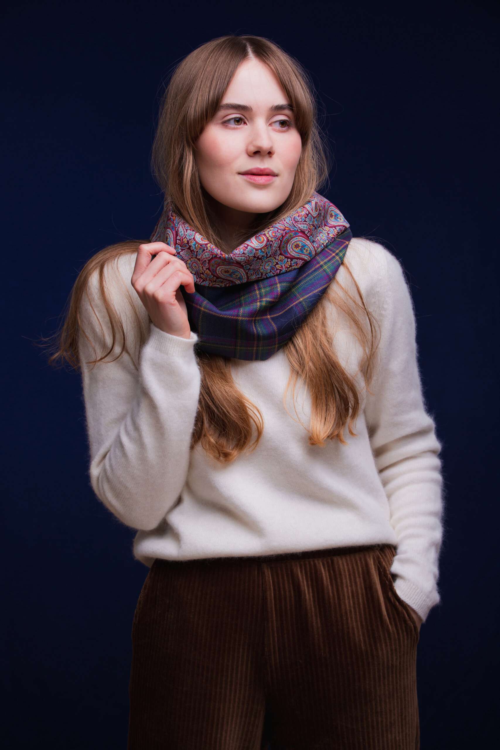 LoullyMakes Studio 4 55 scaled Classic Cowl in our exclusive Highland Mist Tartan with Liberty Print tana lawn cotton lining. Simply select your choice of coloured lining from the drop-down menu. (The example cowl pictured here features lining 7) This easy-to-wear cowl combines effortless styling and sublime warmth, being formed from a simple superfine cotton lined "tube" of 100% wool Highland Mist Tartan. Simply pop over your head and wear the cowl high, to keep out the chill, or roll over the neckline to feature a flourish of an iconic art fabric. 100% Wool Tartan, 100% cotton lining