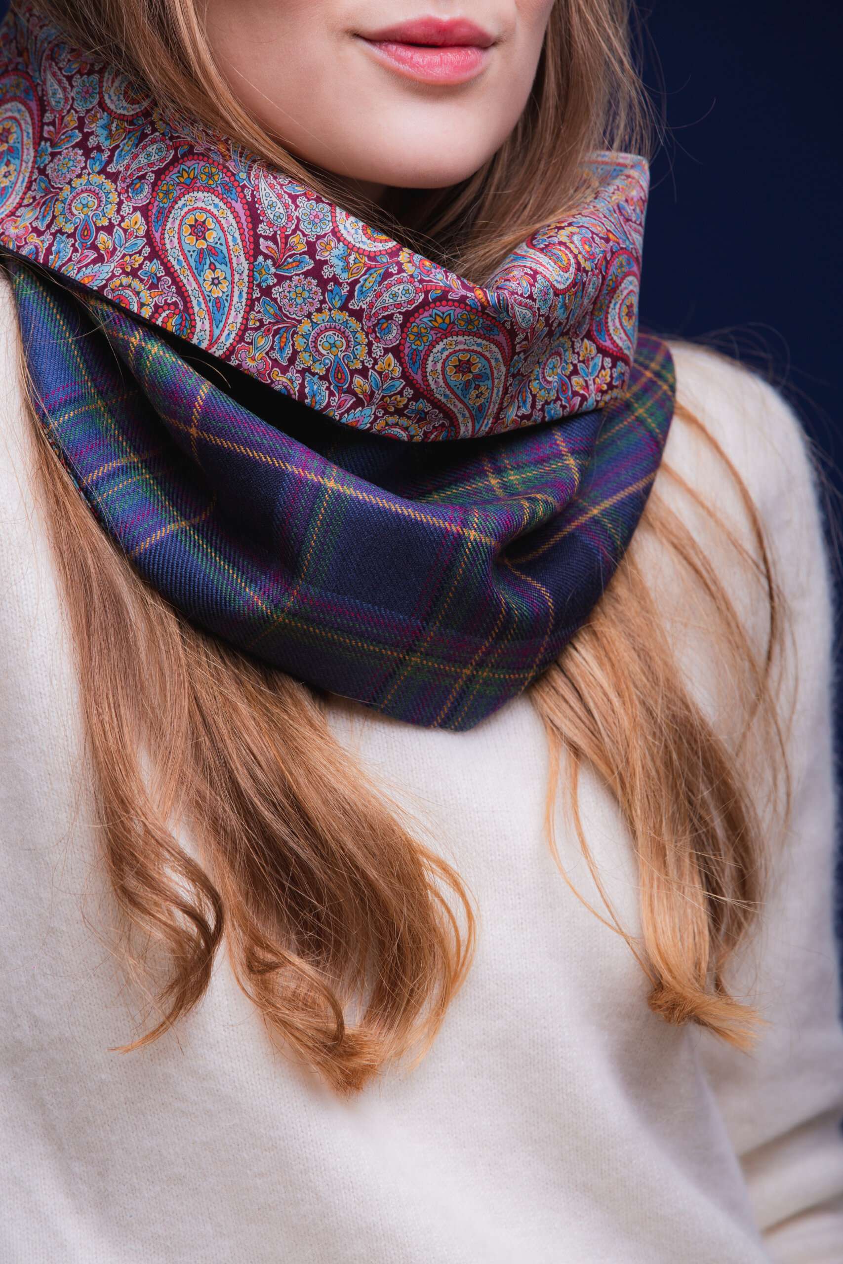 LoullyMakes Studio 4 56 scaled Classic Cowl in our exclusive Highland Mist Tartan with Liberty Print tana lawn cotton lining. Simply select your choice of coloured lining from the drop-down menu. (The example cowl pictured here features lining 7) This easy-to-wear cowl combines effortless styling and sublime warmth, being formed from a simple superfine cotton lined "tube" of 100% wool Highland Mist Tartan. Simply pop over your head and wear the cowl high, to keep out the chill, or roll over the neckline to feature a flourish of an iconic art fabric. 100% Wool Tartan, 100% cotton lining