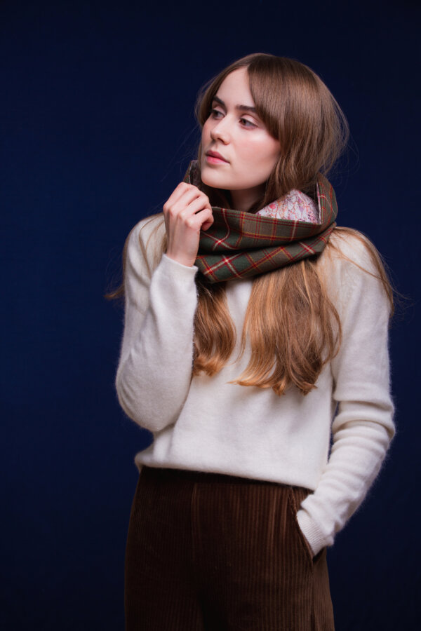 LoullyMakes Studio 4 57 scaled Classic Cowl in our own exclusive Flodden Commemorative Tartan with Liberty Print tana lawn cotton lining. Simply select your choice of coloured lining from the drop-down menu. (The example cowl pictured here features lining 6) This easy-to-wear cowl combines effortless styling and sublime warmth, being formed from a simple superfine cotton lined "tube" of 100% wool Flodden Tartan. Simply pop over your head and wear the cowl high, to keep out the chill, or roll over the neckline to feature a flourish of an iconic art fabric. 100% Wool Tartan, 100% cotton lining