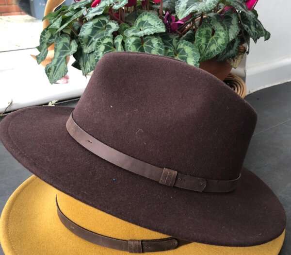 WhatsApp Image 2021 01 29 at 09.12.46 Dark Brown wool felt fedora hat with feather pin. My wool felt fedora hats are beautifully made, water resistant & come complete with a detachable natural game feather pin. Available in sizes; Extra small 53-54cm,  Small 55-56cm & Medium 57-59cm The fedora hat is made from 100% wool felt and suitable to be worn in all weathers.  If the hat does get wet just leave it to dry flat & naturally.