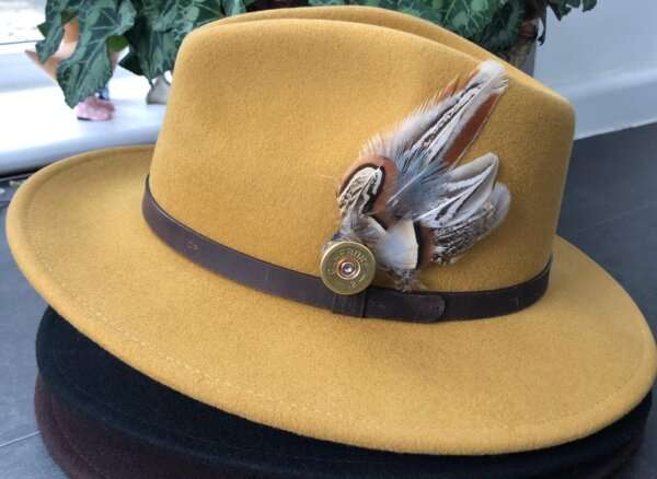 WhatsApp Image 2021 01 29 at 09.12.47 2 Yellow wool felt fedora hat with feather pin. My wool felt fedora hats are beautifully made, water resistant & come complete with a detachable natural game feather pin. Available in sizes; Extra small 53-54cm,  Small 55-56cm & Medium 57-59cm The fedora hat is made from 100% wool felt and suitable to be worn in all weathers.  If the hat does get wet just leave it to dry flat & naturally.