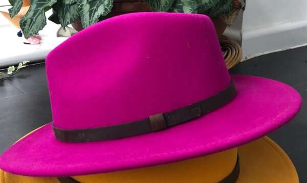 WhatsApp Image 2021 01 29 at 09.12.49 1 Fuscia wool felt fedora hat with feather pin. My wool felt fedora hats are beautifully made, water resistant & come complete with a detachable natural game feather pin. Available in sizes; Extra small 53-54cm,  Small 55-56cm & Medium 57-59cm The fedora hat is made from 100% wool felt and suitable to be worn in all weathers.  If the hat does get wet just leave it to dry flat & naturally.