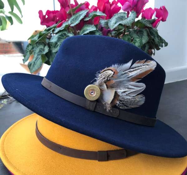 WhatsApp Image 2021 01 29 at 09.12.50 1 Bright Blue wool felt fedora hat with feather pin. My wool felt fedora hats are beautifully made, water resistant & come complete with a detachable natural game feather pin. Available in sizes; Extra small 53-54cm,  Small 55-56cm & Medium 57-59cm The fedora hat is made from 100% wool felt and suitable to be worn in all weathers.  If the hat does get wet just leave it to dry flat & naturally.