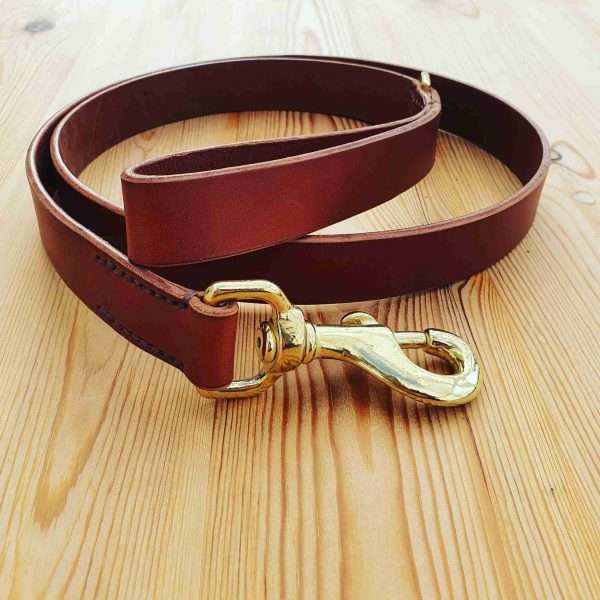 IMG 20210207 202541 696 scaled Hand-crafted leather clip lead, made from the finest English, full grain leather. - Hand-stitched - Solid brass or nickel swivel clip - Available in black, chestnut, dark brown, tan and natural colour leather - Length: Standard (38 inches), Long (48 inches). Width: 1 inch - Can be personalised with your initials, your name, or your dogs name for no additional cost.