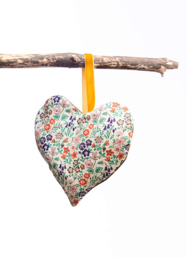 LoullyMakes Xmas produts 73 scaled e1612644049746 Gorgeous hanging heart-shaped herb pillow, lovingly handmade in our own exclusive Flodden Commemorative tartan. These scented sachets are backed with a beautiful Liberty Art Fabric and finished with a velvet ribbon loop and decorative button - so can be hung from coat hangers, drawer handles, bedsteads , coat hooks, Christmas Trees, anywhere you like really. Each heart is filled with my own recipe of dried lavender , chamomile and hops - a combination which acts as a relaxing fragrance in the home. Enliven the scent occasionally by shaking the mix inside the heart, or place near a warm radiator for a fragrance boost . If hung near wardrobes, closets or drawers, this scented herb mix will also keep moths away from your favourite linens and garments ! NB DO NOT PLACE NEAR ANY NAKED FLAME OR DIRECT HEAT SOURCE. All tartans are 100% wool kiltweight woven tartans. Each tartan heart will be backed with a co-ordinating printed tana lawn cotton, which may vary from that pictured.