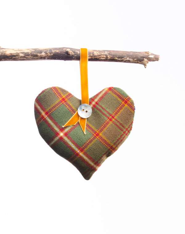 LoullyMakes Xmas produts 74 scaled e1612644005379 Gorgeous hanging heart-shaped herb pillow, lovingly handmade in our own exclusive Flodden Commemorative tartan. These scented sachets are backed with a beautiful Liberty Art Fabric and finished with a velvet ribbon loop and decorative button - so can be hung from coat hangers, drawer handles, bedsteads , coat hooks, Christmas Trees, anywhere you like really. Each heart is filled with my own recipe of dried lavender , chamomile and hops - a combination which acts as a relaxing fragrance in the home. Enliven the scent occasionally by shaking the mix inside the heart, or place near a warm radiator for a fragrance boost . If hung near wardrobes, closets or drawers, this scented herb mix will also keep moths away from your favourite linens and garments ! NB DO NOT PLACE NEAR ANY NAKED FLAME OR DIRECT HEAT SOURCE. All tartans are 100% wool kiltweight woven tartans. Each tartan heart will be backed with a co-ordinating printed tana lawn cotton, which may vary from that pictured.