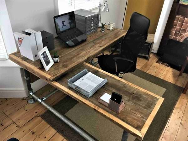 Richmond L shape desk with lowered side 1 scaled <p style="text-align: center">The office desk is a sleek and striking statement piece that will make the very best impression in your reception space or home office. Made from reclaimed scaffold boards with reclaimed heavy-duty steel scaffold tubes for legs.</p>