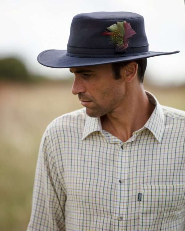 1T1A5715 scaled 1 Internal lining is 100% cotton lining, and an inner trim band for extra comfort. Outer shell is made from 100% waxed cotton, with an attractive stylish feather bush sitting on the top of the hat. Produced to the highest standards by a manufacturer of top quality coiuntrywear and derby clothing. Please check our size guide against your hat you wish to purchase.