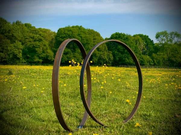 WELCOME TO THE RUSTIC GARDEN ART SHOP Here we have one of our. Rustic Metal Garden Ring Hoop Sculpture - Pair of Rusty Ring Circle Garden Art / Globe / Sphere Interchangeable metal ring sculptures - one is slightly smaller so fits within the other ring with two stakes per ring. Enabling you to arrange your own formation or design. These two rustic garden rings make a unique, versatile garden sculpture. Arrange the rusty metal rings in any formation to create your very own unique piece of affordable garden decor. Our Rustic/Rusty patina gives a natural and unique finish, which will continue to better with age. Our rustic garden art products require absolutely no maintenance! Sizes & Measurements:
Medium: approx 50cm diameter - made from flat steel 30mm x 8mm