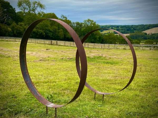 WELCOME TO THE RUSTIC GARDEN ART SHOP Here we have one of our. Rustic Metal Wide Garden Ring Hoop Sculpture - Pair of Rusty Ring Circle Garden Art / Globe / Sphere Interchangeable metal ring sculptures - one is slightly smaller so fits within the other ring with two stakes per ring. Enabling you to arrange your own formation or design. These two rustic garden rings make a unique, versatile garden sculpture. Arrange the rusty metal rings in any formation to create your very own unique piece of affordable garden decor. Our Rustic/Rusty patina gives a natural and unique finish, which will continue to better with age. Our rustic garden art products require absolutely no maintenance! Sizes & Measurements:
Large - Approx 100cm diameter -made from flat steel 90mm wide