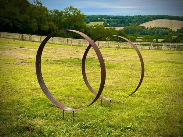 WELCOME TO THE RUSTIC GARDEN ART SHOP Here we have one of our. Rustic Metal Wide Garden Ring Hoop Sculpture - Pair of Rusty Ring Circle Garden Art / Globe / Sphere Interchangeable metal ring sculptures - one is slightly smaller so fits within the other ring with two stakes per ring. Enabling you to arrange your own formation or design. These two rustic garden rings make a unique, versatile garden sculpture. Arrange the rusty metal rings in any formation to create your very own unique piece of affordable garden decor. Our Rustic/Rusty patina gives a natural and unique finish, which will continue to better with age. Our rustic garden art products require absolutely no maintenance! Sizes & Measurements:
Medium - Approx 50cm diameter -made from flat steel 90mm wide