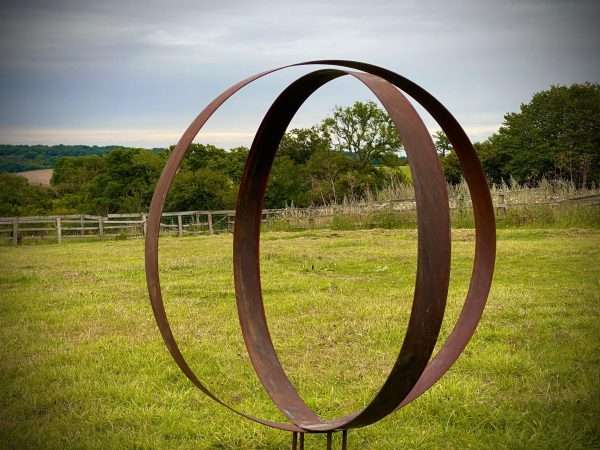 WELCOME TO THE RUSTIC GARDEN ART SHOP Here we have one of our. Rustic Metal Wide Garden Ring Hoop Sculpture - Pair of Rusty Ring Circle Garden Art / Globe / Sphere Interchangeable metal ring sculptures - one is slightly smaller so fits within the other ring with two stakes per ring. Enabling you to arrange your own formation or design. These two rustic garden rings make a unique, versatile garden sculpture. Arrange the rusty metal rings in any formation to create your very own unique piece of affordable garden decor. Our Rustic/Rusty patina gives a natural and unique finish, which will continue to better with age. Our rustic garden art products require absolutely no maintenance! Sizes & Measurements:
Large - Approx 100cm diameter -made from flat steel 90mm wide