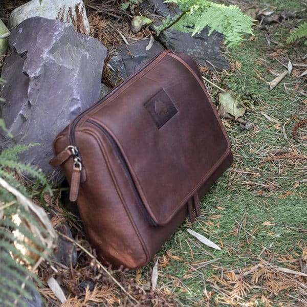 9007 w3 Keep your toiletries together in style with this durable yet classy wash-bag, made from dark brown oiled leather. With plenty of zipped pockets and storage options, it’s the ideal travel accessory. Hang it on the door for a practical and elegant way to save space in your bathroom. Perfect for both summer and winter trips.! Optional Personalisation