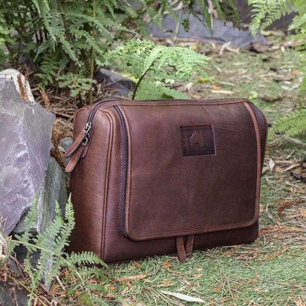 9007 w5 Keep your toiletries together in style with this durable yet classy wash-bag, made from dark brown oiled leather. With plenty of zipped pockets and storage options, it’s the ideal travel accessory. Hang it on the door for a practical and elegant way to save space in your bathroom. Perfect for both summer and winter trips.! Optional Personalisation