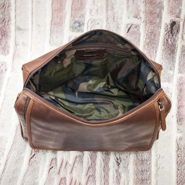 9007col w6 Keep your toiletries together in style with this durable yet classy wash-bag, made from dark brown oiled leather. With plenty of zipped pockets and storage options, it’s the ideal travel accessory. Hang it on the door for a practical and elegant way to save space in your bathroom. Perfect for both summer and winter trips.! Optional Personalisation