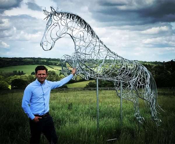 Blue Memory Jumping Horse Sculpture Gallery 5 SOLD ALL COMMISSIONS WELCOME   Our NEW Jumping Horse Sculpture ‘Blue Memory’ By British Sculptor Charles Elliott was inspired by the late World Champion jumping stallion Plot Blue, ridden by Marcus Ehning- When creating each sculpture, Charles uses inspiration from various horses, studying characteristics and proportions. Whilst putting his finishing touches to this Plot Blue inspired sculpture, we were shocked to receive news of his passing. ‘Blue Memory’ Sculpture will be on show at Bolesworth International Horse Show and Al’Shiara Hickstead Derby & Nation Cups in 2019 - This Handcrafted Life Size Jumping Horse Sculpture forms the latest one off sculpture of The Elliott of London Equestrian Sculpture Range. Handmade from 8mm round mild steel to indicate power and flow, luxurious progressive zinc exterior galvanised finish to protect the piece from nature and rust for over 30 years! Worldwide Shipping and International Delivery & Installation Available! All Enquiries Welcome - Available to Buy, as well as long term and short term hire! Approx Dimensions L= 340cm H= 280cm W= 70cm Studio Office - 01494758896 Charles - 07591730415 Website: www.elliottoflondon.co.uk Email:info@elliottoflondon.co.uk Viewing Welcome by Appointment only