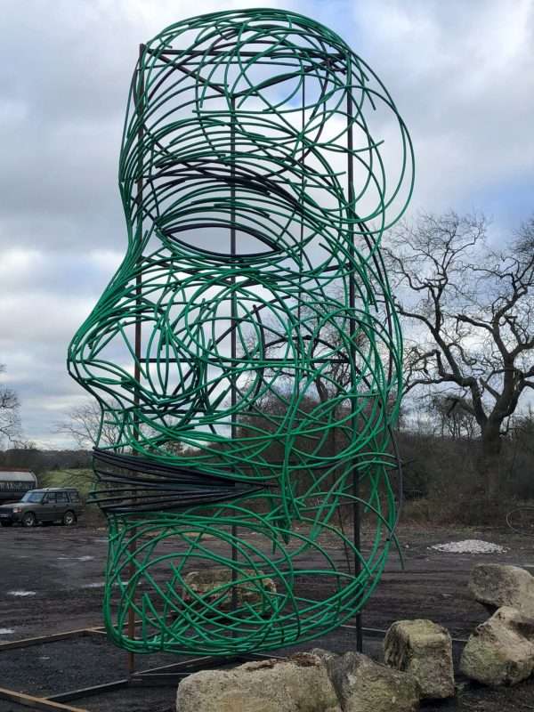 FACING FEARS SCULPTURE Gallery 5 Elliott of London 'Facing Fears'   By British Sculptor Charles Elliott This 9 Metres high abstract face sculpture was designed and handcrafted by Charles from recycled plastic tubes. Created in response to national fears of 2018, with Brexit and various other environmental issues surrounding global warming and Plastic Recycling. At present Recycling Markets send 500,000 tons of plastic a year to China to be recycled, which has been stopped as of 1st January 2018. This poses various issues to the UK Recycling Industry.   This large powerful and controversial sculpture can be seen on show outside Elliott of London NEW Berkhamsted Based Sculpture Studio next to A41. Charles and his team welcome visitors to see and picture the piece safely from their premises!   Studio Office - 01494758896 Charles - 07591730415 Website: www.elliottoflondon.co.uk Email: info@elliottoflondon.co.uk   #recycling #plasticrecycling #recycleplastic #ukrecycling #sculpture #artist #britishsculptor #charleselliott #humanface #faceart #femaleface #figurative #britishsculpture #abstractart #abstractsculpture #contraversial #globalwarming #enviromentalissues #recycledart #upcycled #upcycling #reuseable #renewable #waste #scrapplastics #hdpe #siliconeplastic