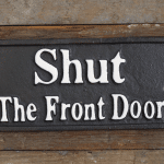 Cast iron Shut The Front Door Sign