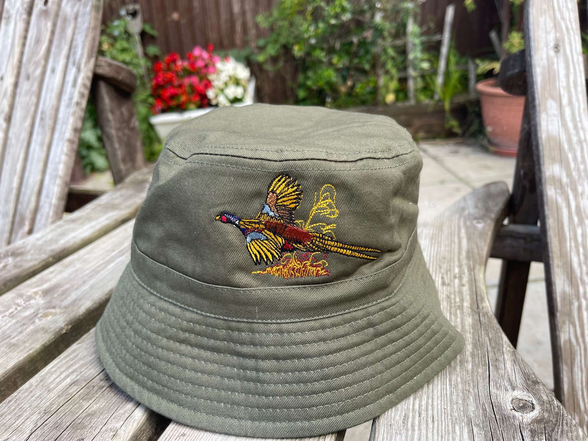 IMG 7200 1 Bucket Hat with Pheasant embroidery logo. Available in French Navy / White underside, Olive Green / Stone underside & Black / Light Grey Underside 100% Cotton Twill Short brim. Stitched ventilation eyelets. BSCI certified. Reach certified.