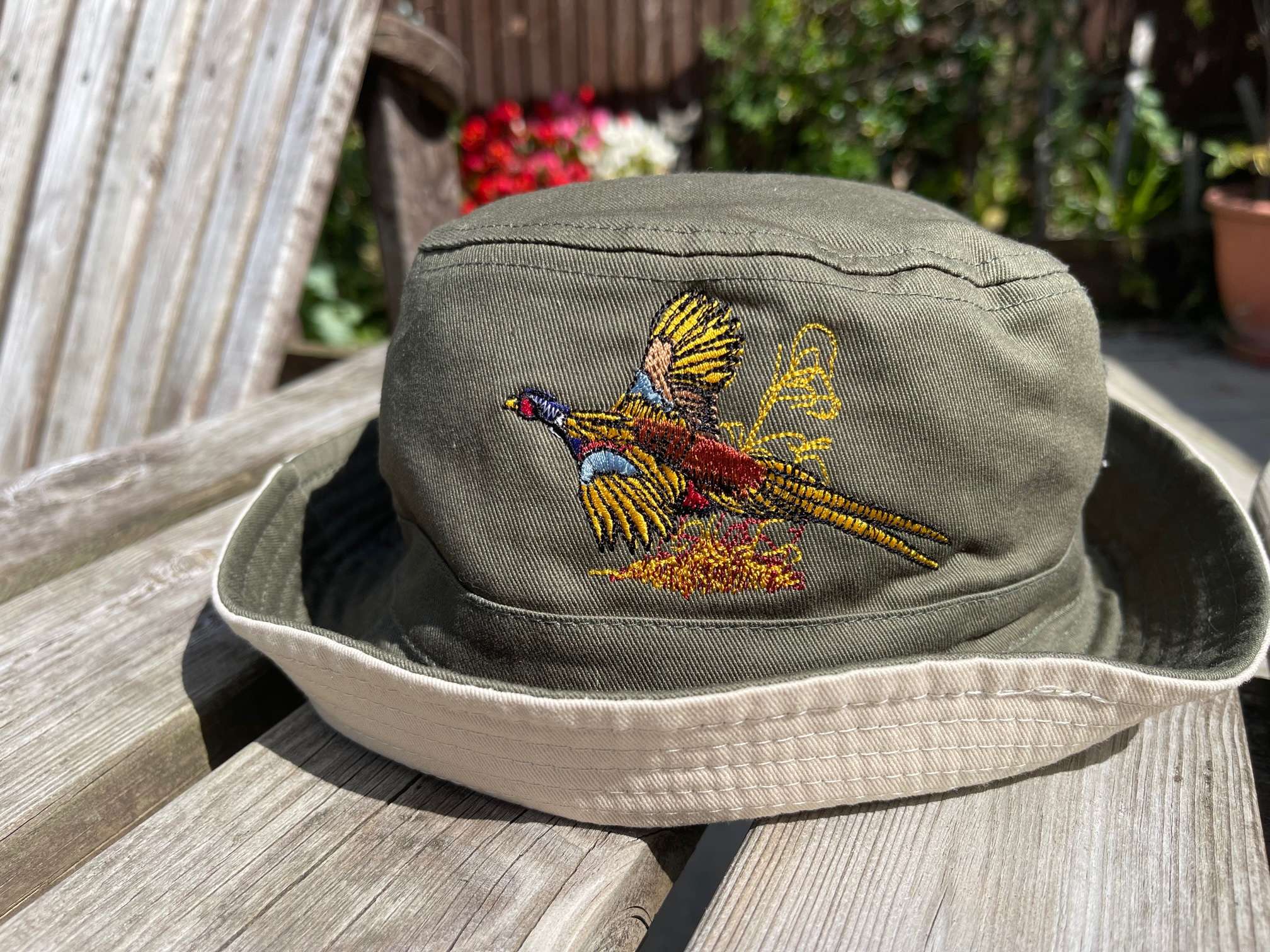 IMG 7214 Bucket Hat with Pheasant embroidery logo. Available in French Navy / White underside, Olive Green / Stone underside & Black / Light Grey Underside 100% Cotton Twill Short brim. Stitched ventilation eyelets. BSCI certified. Reach certified.