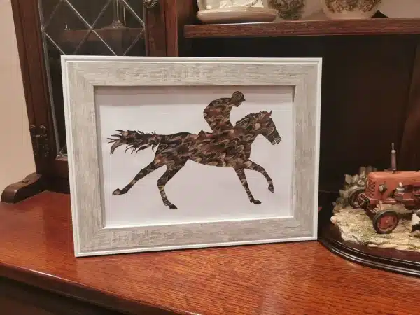 Galloping Feather Racehorse -Shooting Gift -Racing Gift - Game Bird Gift -Pheasant Feather Silhouette Present - Horse Racing. National Hunt Beautiful handmade feather silhouette crafted with hand picked pheasant feathers. Sure to look great in any home or shooting lodge or racing themed house. Picture comes framed and can be mounted if wished. Due to the nature of the feathers no two pictures are the same so may differ slightly from the listing picture. All the feathers are 100% locally sourced and the picture hand crafted on our farm in Devon. Perfect as a gift for anyone with a country/shooting or hunting theme Gift can be personalised with writing or different feathers. Other frames available - please specify in the customisation if you would like a dark, wooden or light frame Available in various sizes