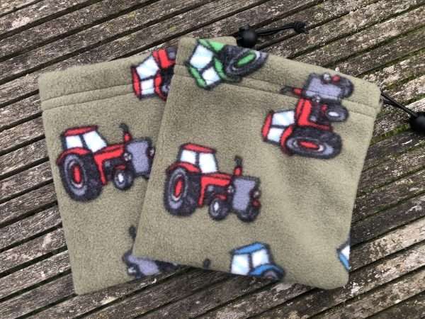 IMG 5519 scaled Fleece Stirrup Covers - khaki with tractor print (placement of pattern will vary with each stirrup cover) These help protect your saddle from any scuffs and scratches from the stirrups. Ideal in winter to help keep your saddle clean from dirty stirrups after riding. Can also be used to store your stirrups when not in use. Sent via Royal Mail