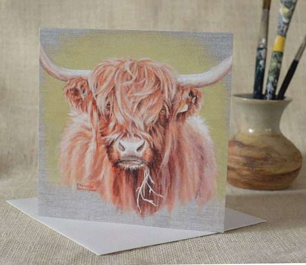 Highland Cow square art birthday card. Blank inside. Viewed standing on card, small vase and paint brushes in the background.