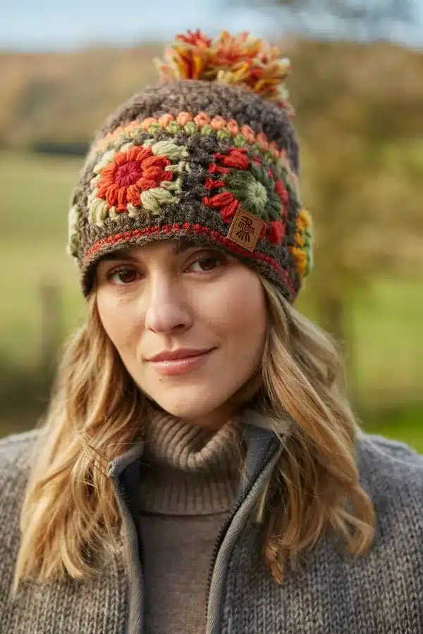 woodstockbobble1 1 <p style="text-align: center"><strong><span style="font-size: 18pt">Woodstock Inspired, Hand Crocheted Bobble Hat</span></strong></p> <p style="text-align: center">Women's hand crocheted wool bobble hat , with crochet granny squares. Earthy brown shades.</p> <div style="text-align: center">Woodstock - Hand crocheted traditional granny squares in warm, earthy tones.</div> <ul style="text-align: center"> <li><span style="font-size: x-large">100% Wool</span></li> <li><span style="font-size: x-large">Fleece lined</span></li> <li><span style="font-size: x-large">Crocheted by hand</span></li> <li><span style="font-size: x-large">Fair Trade and Handmade in Nepal</span></li> </ul> <p style="text-align: center"><b>Colours and patterns may vary slightly due to the handmade nature of this product. </b></p> <div class="row"> <div id="item_price" class="col-sm-12"> <p style="text-align: center"><b>No two items are exactly the same!</b></p> <p style="text-align: center"><b>Handwarmers and headband available in this pattern.</b></p> <p style="text-align: center">All colours are represented as closely as possible, we cannot guarantee 100% accuracy.</p> <h1 style="text-align: center"><strong>FREE P&P</strong></h1> </div> </div>