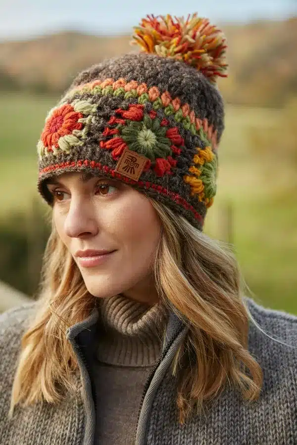 woodstockbobble3 <p style="text-align: center"><strong><span style="font-size: 18pt">Woodstock Inspired, Hand Crocheted Bobble Hat</span></strong></p> <p style="text-align: center">Women's hand crocheted wool bobble hat , with crochet granny squares. Earthy brown shades.</p> <div style="text-align: center">Woodstock - Hand crocheted traditional granny squares in warm, earthy tones.</div> <ul style="text-align: center"> <li><span style="font-size: x-large">100% Wool</span></li> <li><span style="font-size: x-large">Fleece lined</span></li> <li><span style="font-size: x-large">Crocheted by hand</span></li> <li><span style="font-size: x-large">Fair Trade and Handmade in Nepal</span></li> </ul> <p style="text-align: center"><b>Colours and patterns may vary slightly due to the handmade nature of this product. </b></p> <div class="row"> <div id="item_price" class="col-sm-12"> <p style="text-align: center"><b>No two items are exactly the same!</b></p> <p style="text-align: center"><b>Handwarmers and headband available in this pattern.</b></p> <p style="text-align: center">All colours are represented as closely as possible, we cannot guarantee 100% accuracy.</p> <h1 style="text-align: center"><strong>FREE P&P</strong></h1> </div> </div>