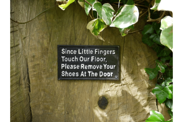 Cast iron Since little fingers touch our floor, please remove your shoes at the door sign