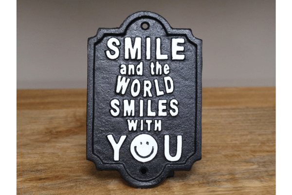 Cast iron smile and the world smiles with you sign