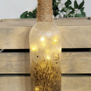 Standard wine bottle with decoupage Hedgehog detail, lit up with cork LED lights and twine wound all the way down the neck of the bottle