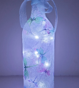 lit up wine bottle with pastel coloured dragonflies pattern, pale blue organza ribbon